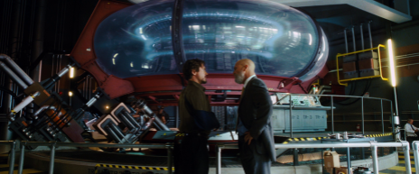 Tony and Obadiah Stane having a conversation in front of the original Arc Reactor at the Stark Industries Headquarters.
