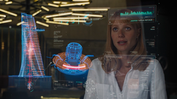 Pepper Potts views the Stark Tower and new Arc Reactor schematics.